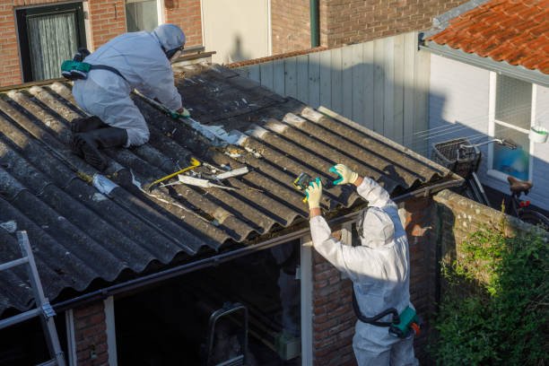 Top-Rated Residential Asbestos Abatement Contractors for Residential Buildings 2 Two men in protective suits safely removing asbestos while working on a roof.