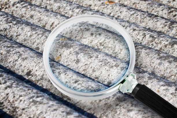 24/7 Asbestos Removal & Cleanup Services in Bellevue, Washington 2 A magnifying glass placed on a metal roof, representing the focus on asbestos removal and cleanup.